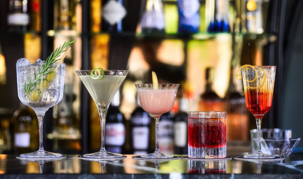 Five cocktails on a bar