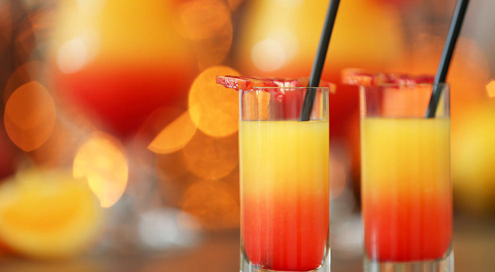 2 Tequila Sunrise cocktails with straws
