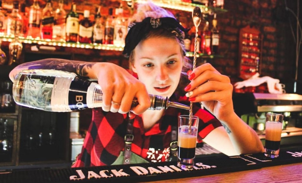 Bartender layering a B52 cocktail shot