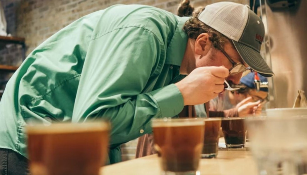 Man smelling coffee during coffee cupping