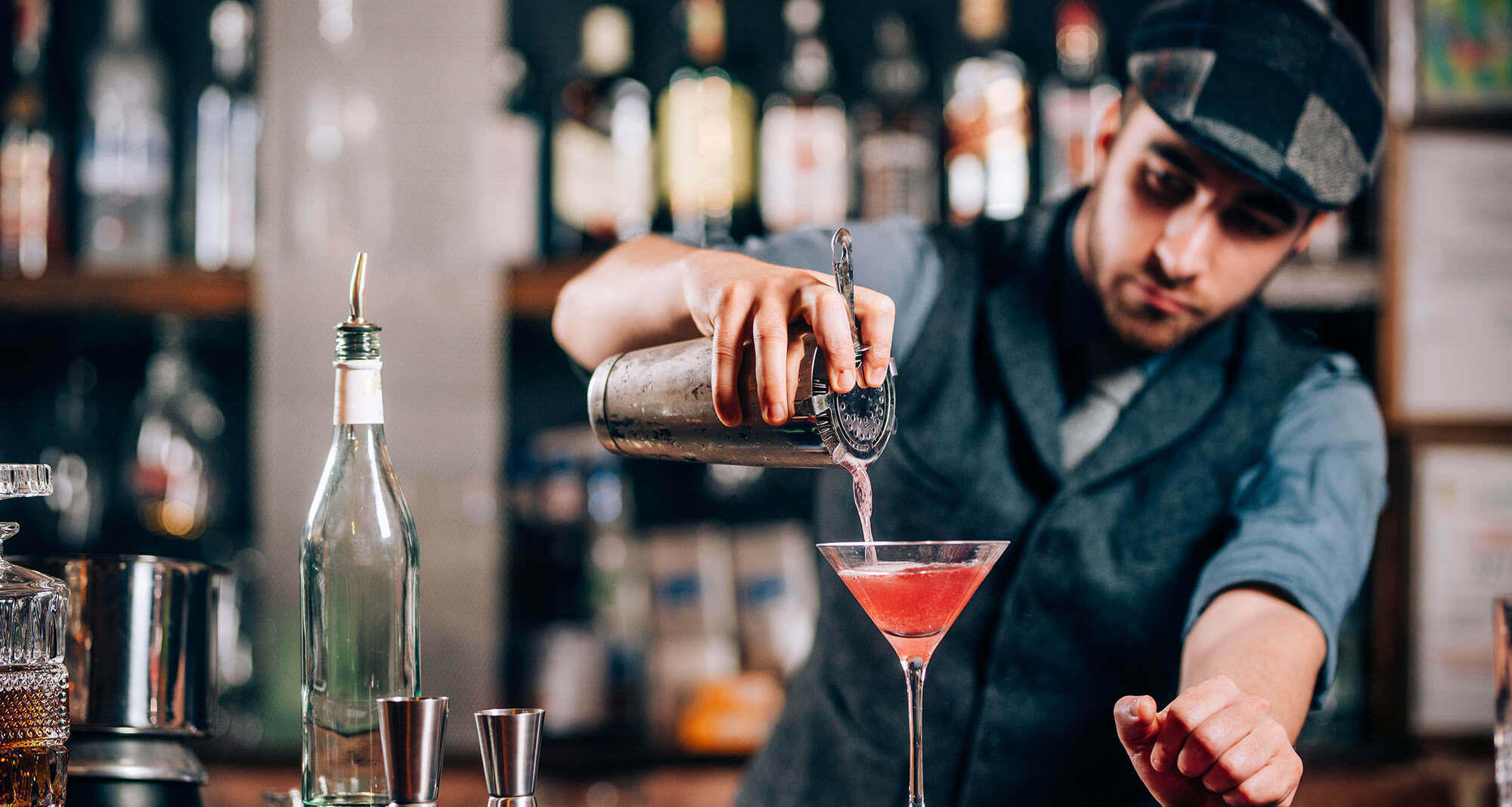 bartender pouring a cocktail