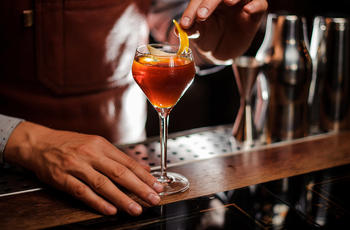 bartender garnishing cocktail