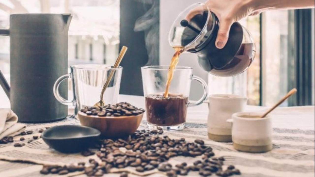 Person pouring coffee from coffee strainer