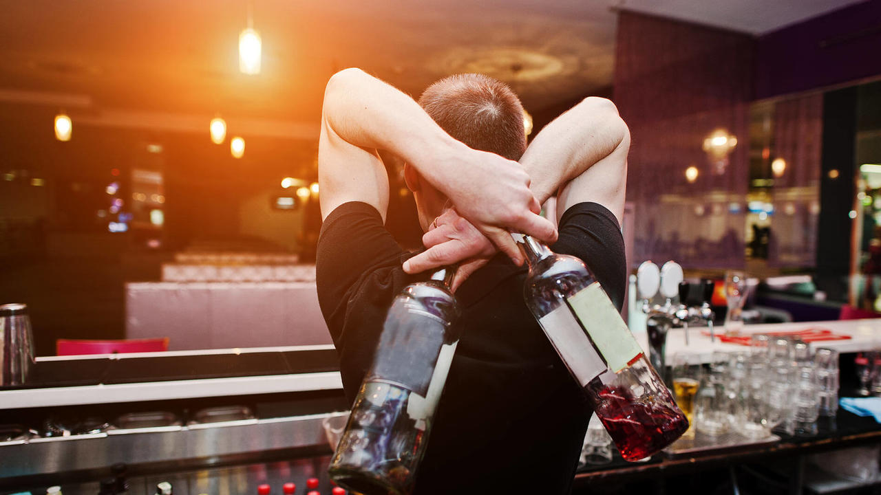 bartender holding bottles