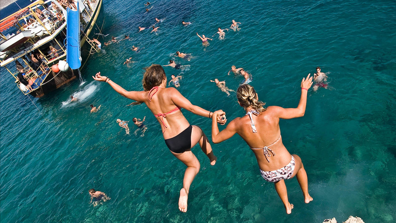 girls jumping boat