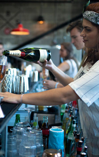 Élèves du cours de bartending EBS apprenant dans un vrai environnement de bar