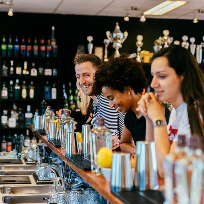 people smiling in bartender school in Amsterdam