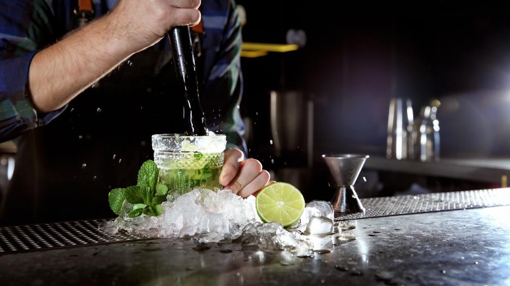 bartender muddling mojito cocktail